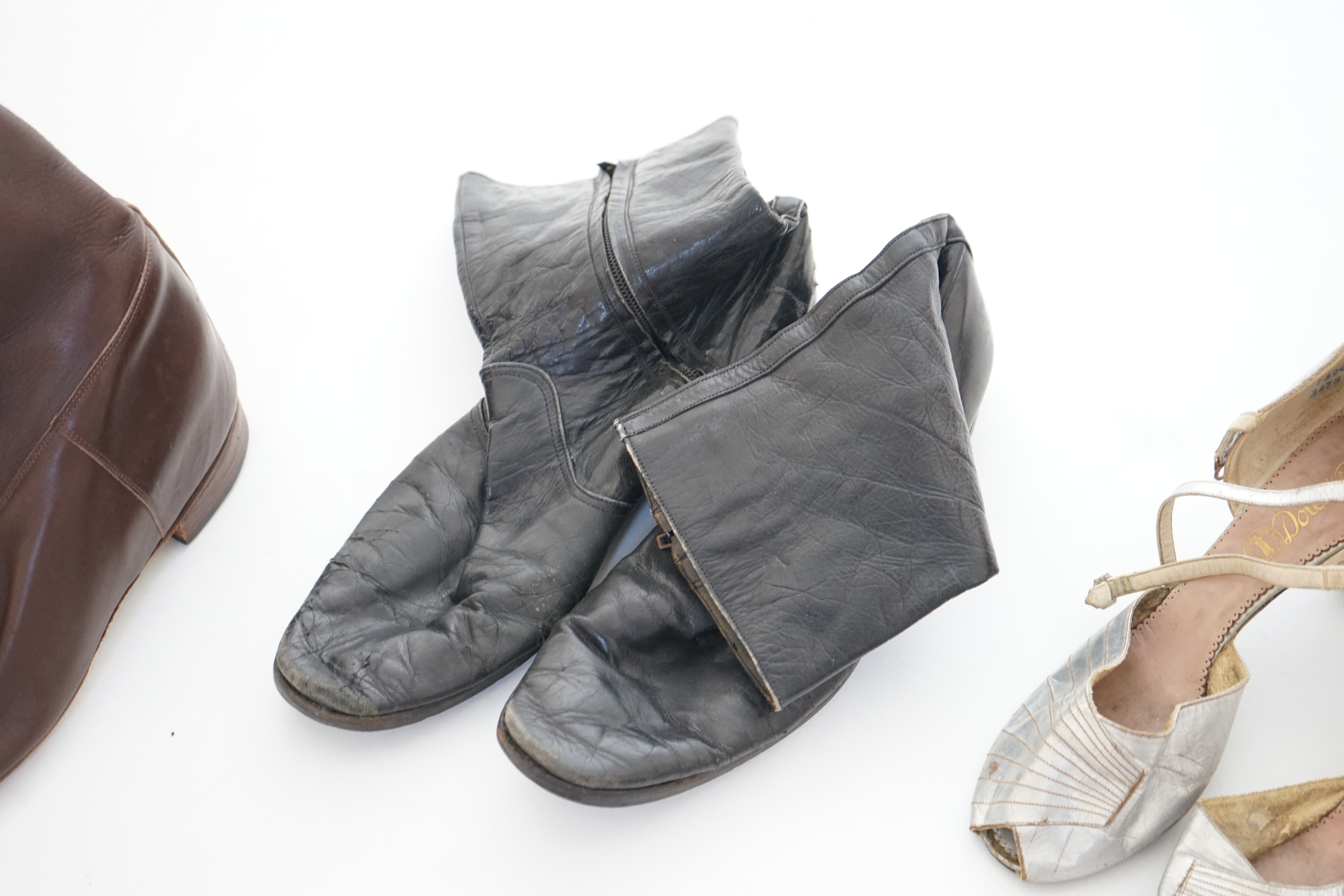 A box of assorted lady's and men's boots and shoes.